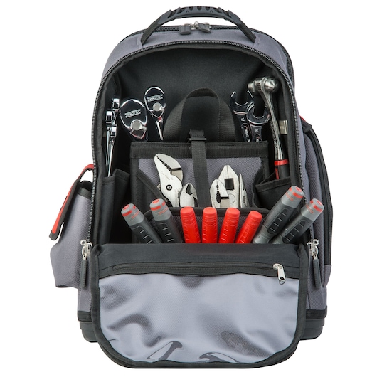 PROTO J114BP tool backpack with front pocket open, showing assorted hand tools with red and gray handles inside organized slots.