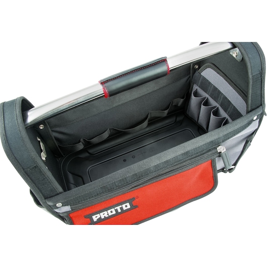 Top view of an open PROTO-branded tool bag with a metal handle, multiple inner pockets, and a large central compartment. The bag is made of black and red fabric and has a zipper on the side.