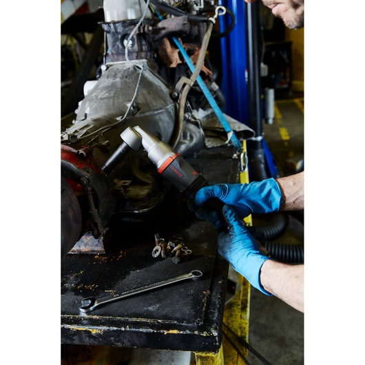 PROTO J150WA air tool being used on machinery by a person wearing blue gloves in a workshop.