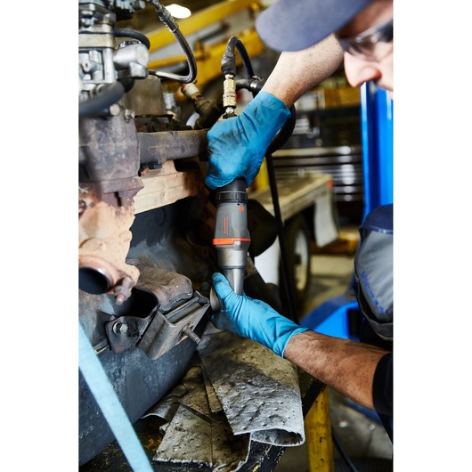 PROTO J150WA pneumatic impact wrench being used by a mechanic with blue gloves on an engine part.
