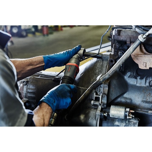 PROTO J150WA angle impact wrench used by gloved hands working on machinery in a workshop setting.