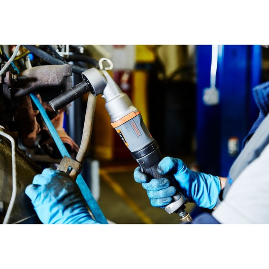 PROTO J150WA pneumatic angle impact wrench used by mechanic with blue gloves on machinery.