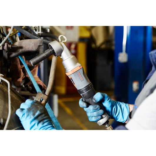 PROTO J150WA pneumatic angle wrench held by a worker in blue gloves during industrial maintenance.