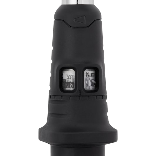 Close-up view of a black torque wrench handle showing two small windows with scale indicators for measuring torque in pound and Newton meter units.