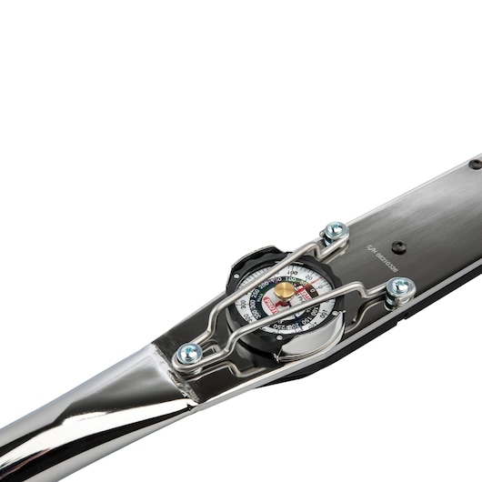 Close-up view of a PROTO dial torque wrench with a metal handle, showing a detailed measurement dial and a protective wire guard.