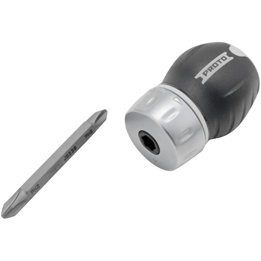 A PROTO brand stubby ratcheting screwdriver with detachable dual-ended bit, shown with the handle and bit separated. The handle is black and silver, labeled PROTO.