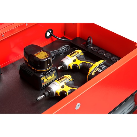 PROTO JUC3743-3SG tool chest drawer with two DeWalt cordless impact drivers, battery charger, and power strip inside.